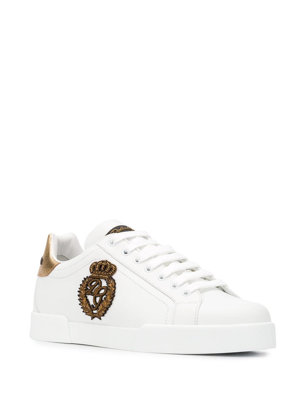White sneaker with golden crown detail