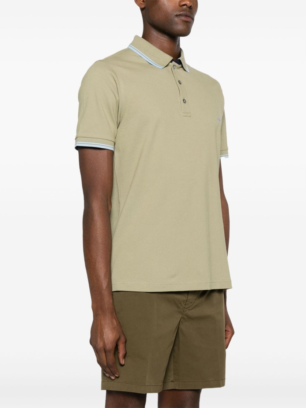 Green polo shirt with piping