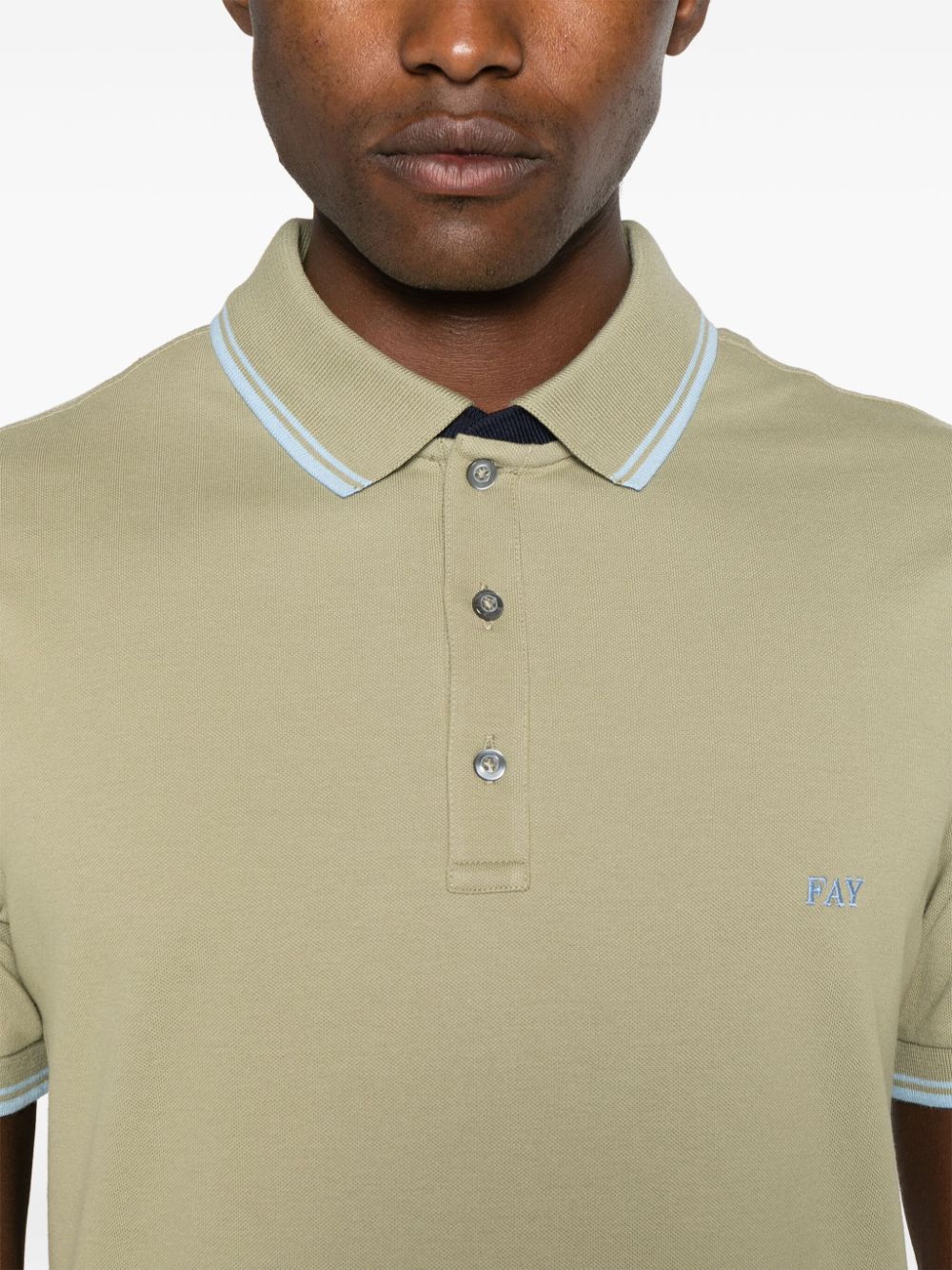 Green polo shirt with piping
