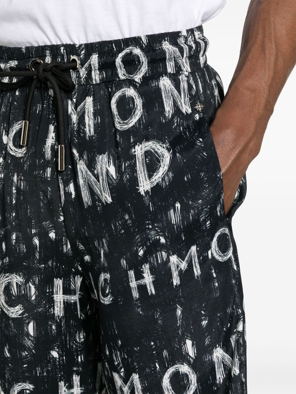 Black Bermuda shorts with all over print