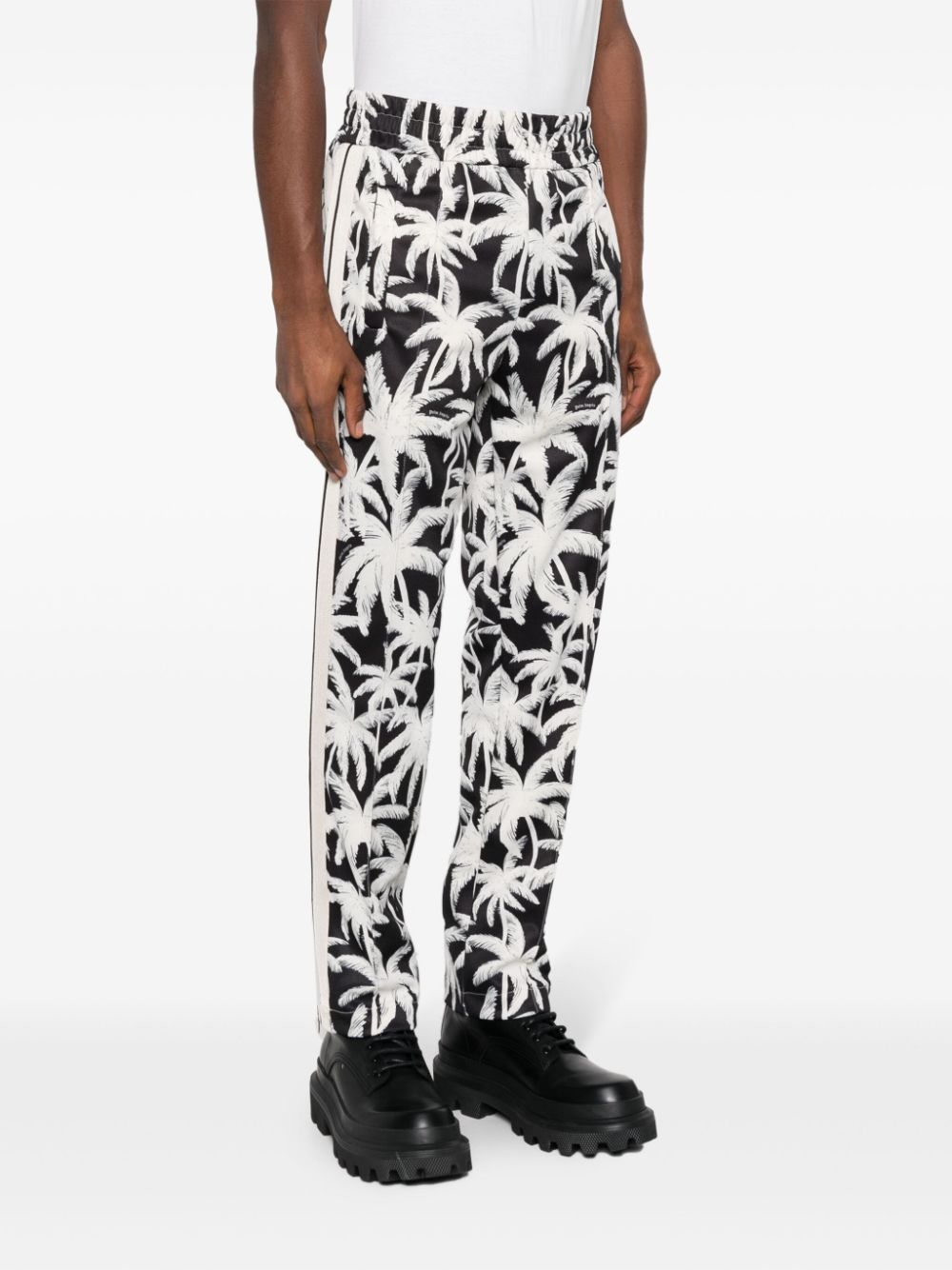 Black trousers with all over palm logo