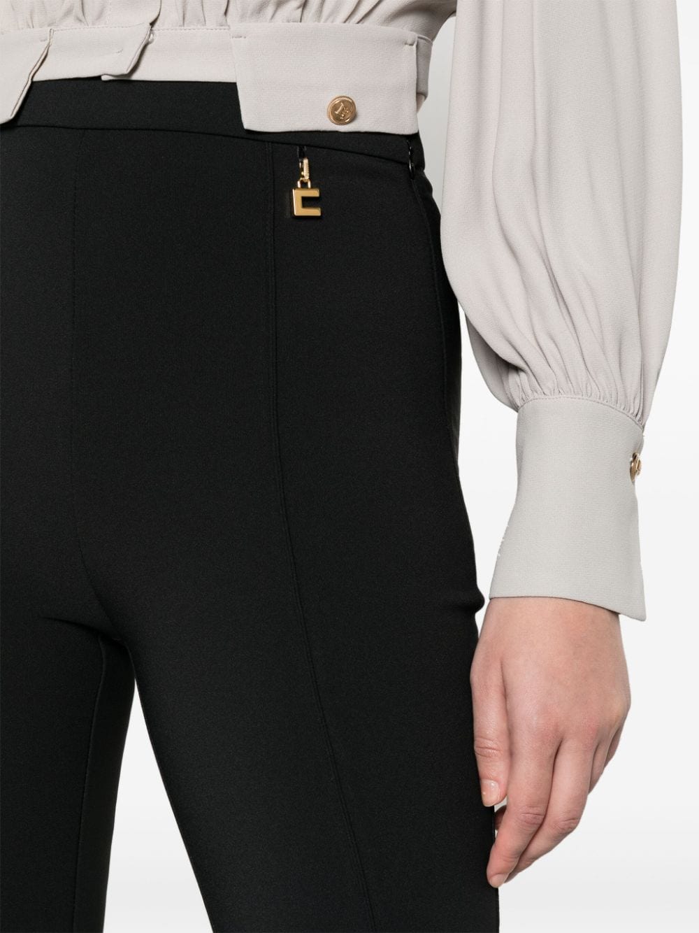 Trousers with logo plaque