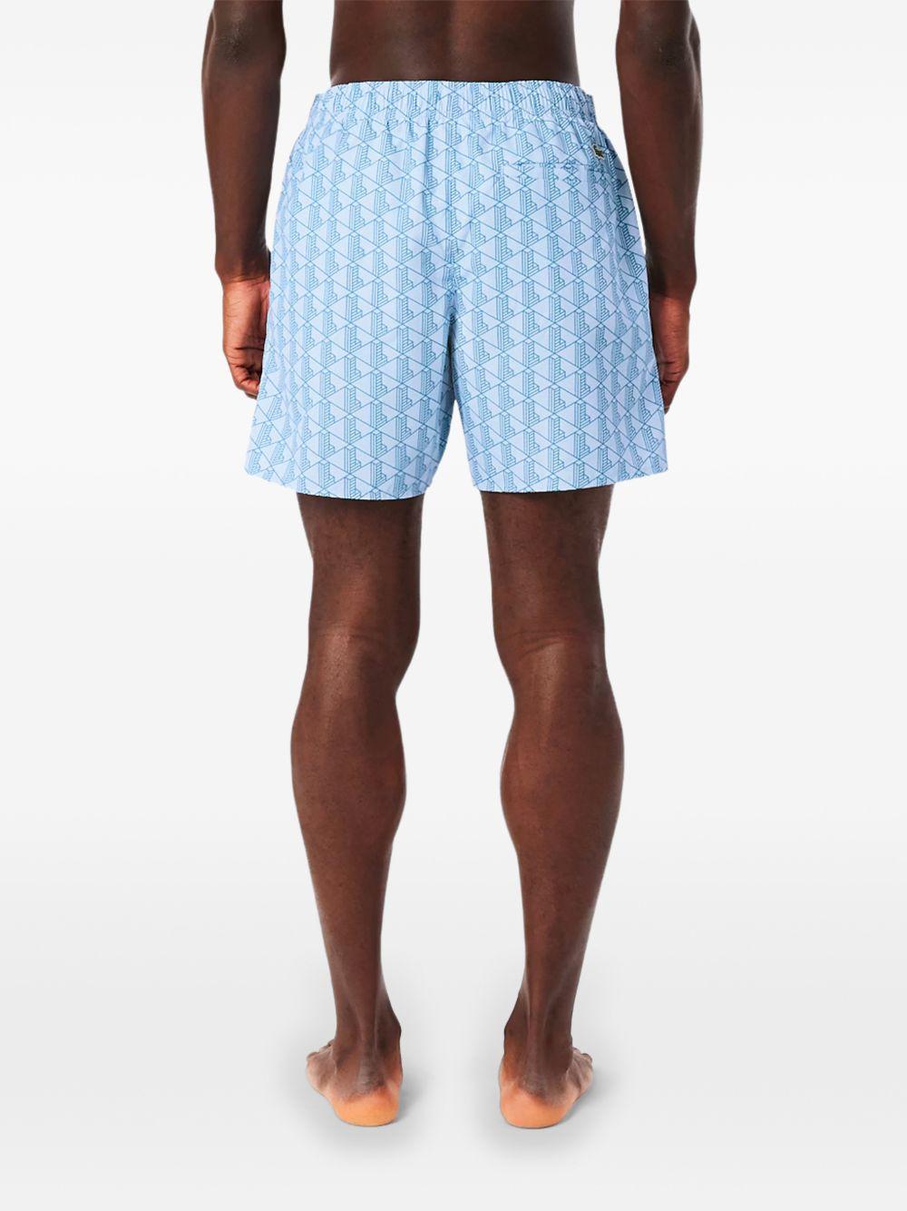 Costume bianco e azzurro con stampa geometrica 
