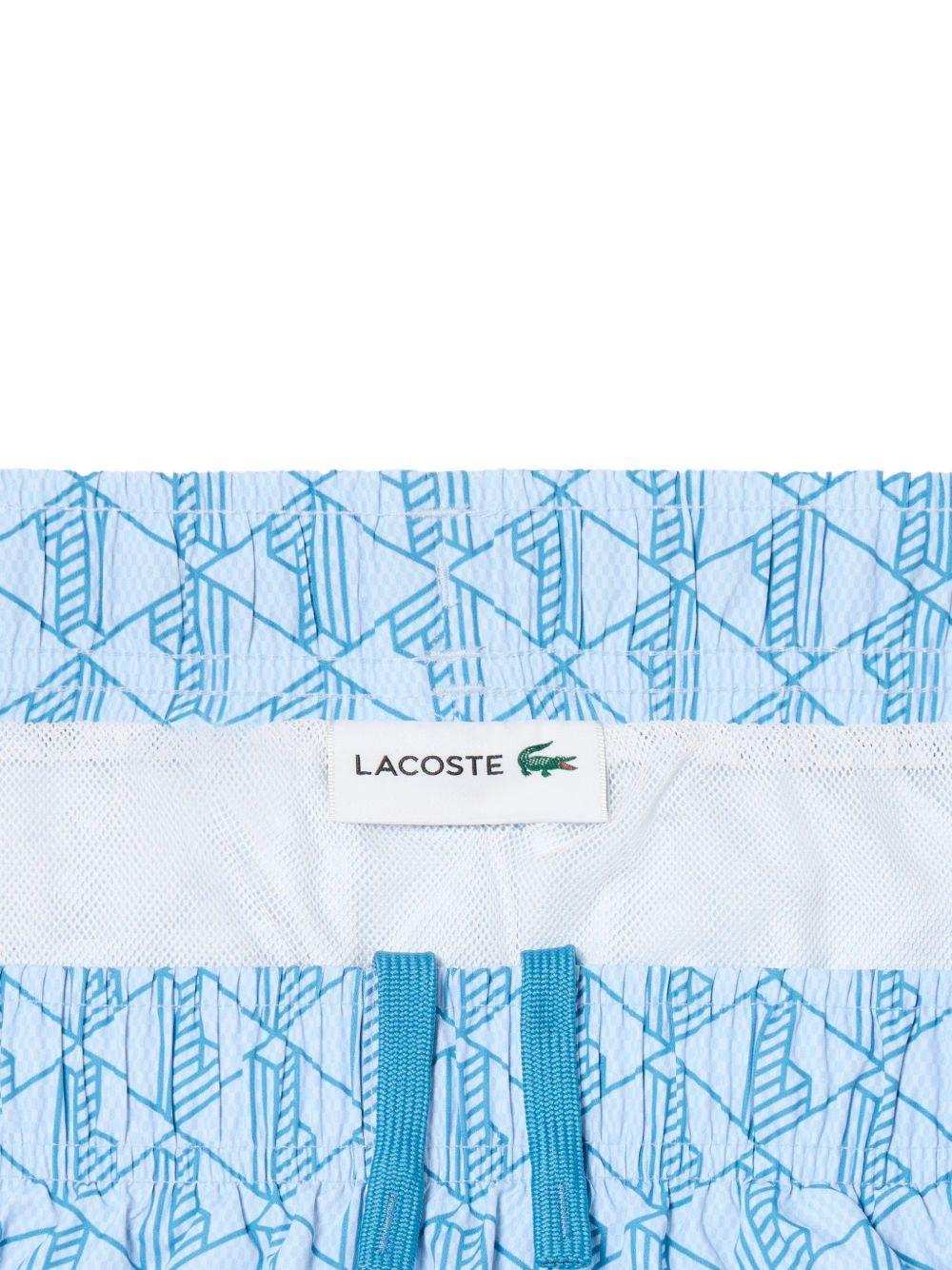 Costume bianco e azzurro con stampa geometrica 
