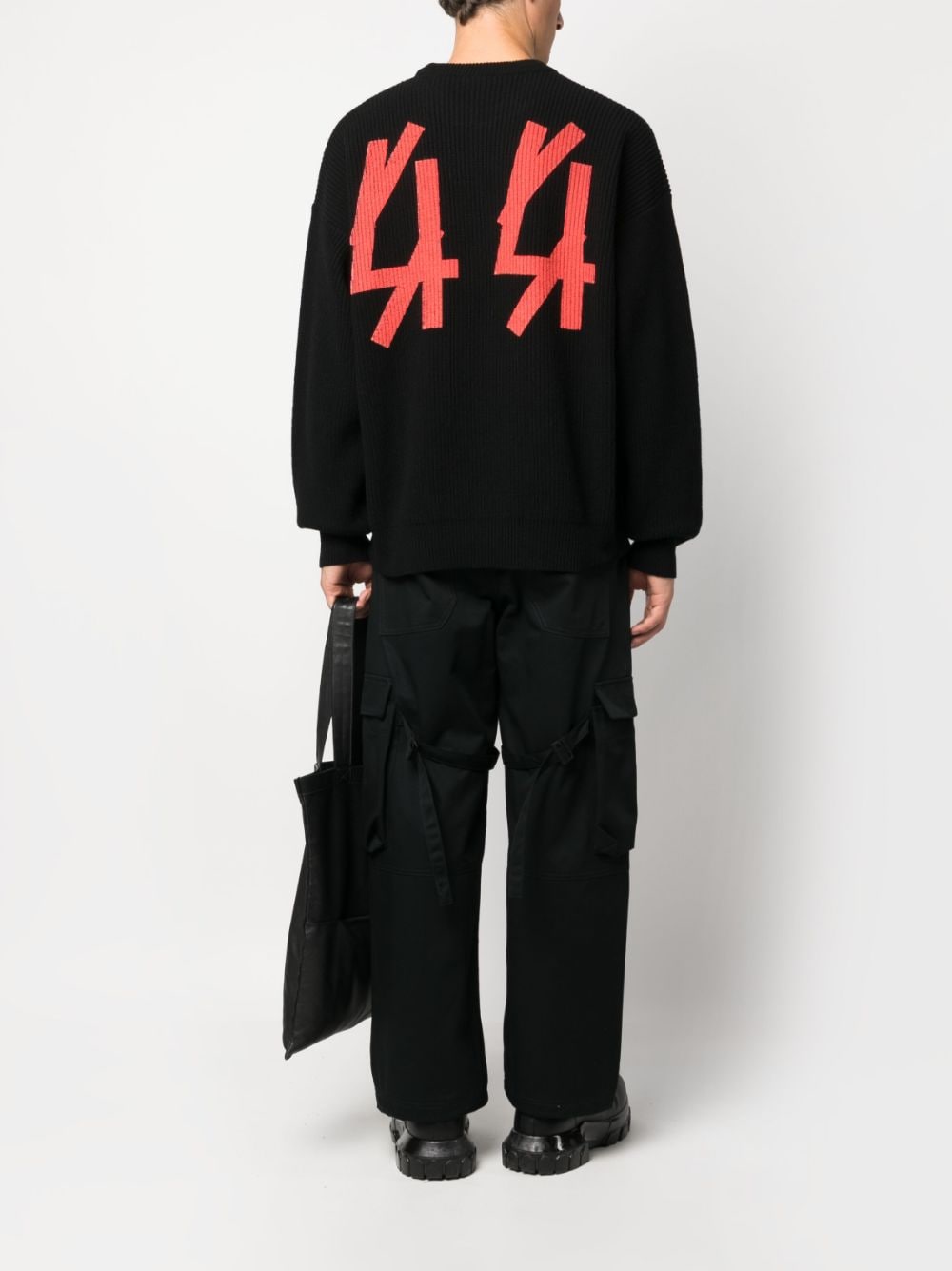 black sweater with red logo on the back