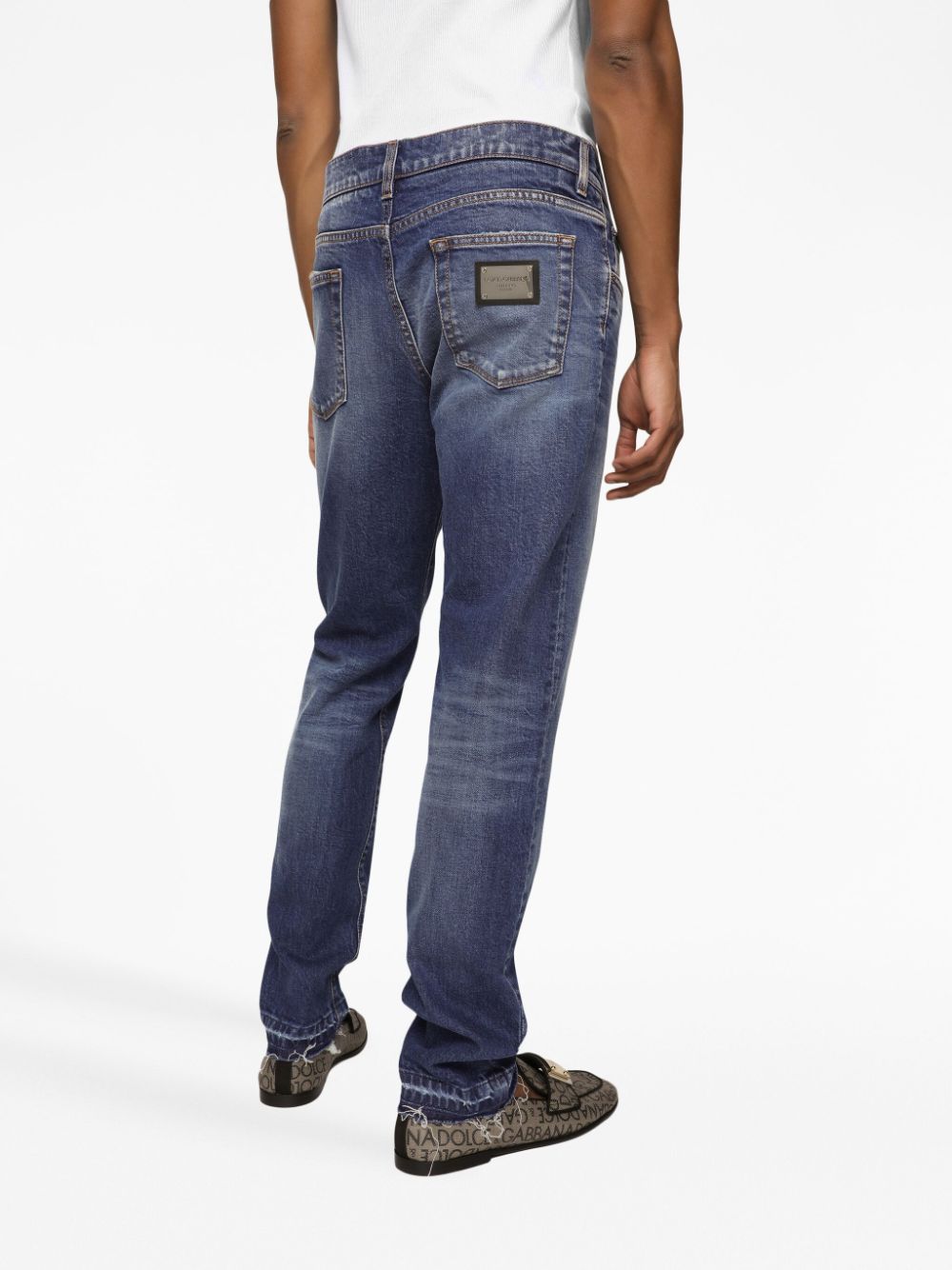 blue jeans with silver logo patch