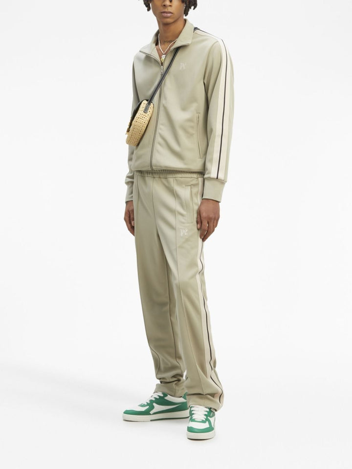 sage green track trousers with monogram logo