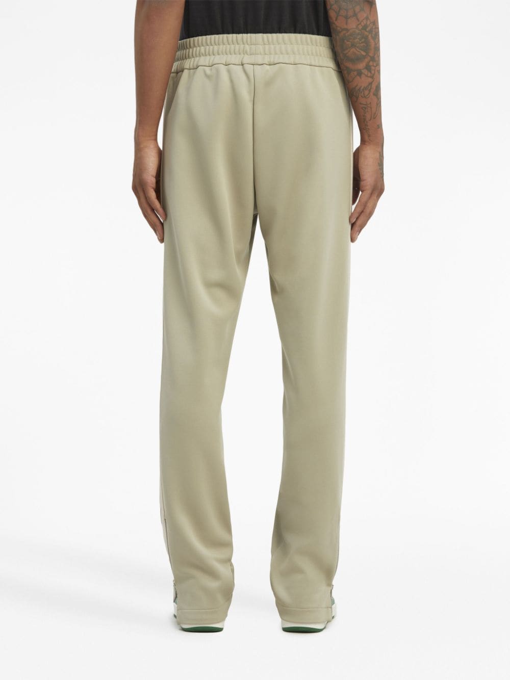 sage green track trousers with monogram logo
